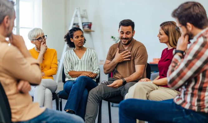 A man being supported at group therapy during dialectical behavior therapy in Nashville